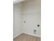 Practical laundry room with wood-look flooring, wire shelving, and necessary hookups for washer and dryer at 1630 Troon Dr, Salisbury, NC 28144