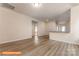 Open-concept living room with wood-look floors and access to the kitchen with a countertop bar area at 1630 Troon Dr, Salisbury, NC 28144