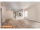 Open-concept living room with wood-look floors, natural light, and an adjoining white kitchen with stainless appliances at 1630 Troon Dr, Salisbury, NC 28144