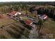 Aerial view of expansive property with multiple barns at 172 Tuckertown Rd, New London, NC 28127