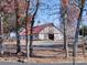 White barn with red roof and driveway, surrounded by autumn trees at 172 Tuckertown Rd, New London, NC 28127