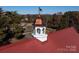 Rustic barn with red metal roof and cupola, nestled on a sprawling property at 172 Tuckertown Rd, New London, NC 28127