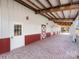 Brick paved walkway leads to barn with multiple exterior stalls at 172 Tuckertown Rd, New London, NC 28127