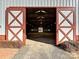 Open barn doors reveal an indoor riding arena at 172 Tuckertown Rd, New London, NC 28127