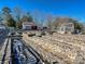 Landscaped garden with stone walls and a greenhouse at 172 Tuckertown Rd, New London, NC 28127