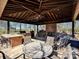Outdoor kitchen and seating area under a pergola at 172 Tuckertown Rd, New London, NC 28127
