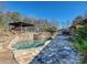 Inviting pool and stone patio with a pergola at 172 Tuckertown Rd, New London, NC 28127