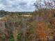 Picturesque aerial shot of a vast lot featuring views of rolling hills and mature trees at 2073 Mauney Rd, Bessemer City, NC 28016