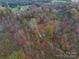An aerial view of a spacious property with dense trees and a long, private driveway at 2073 Mauney Rd, Bessemer City, NC 28016