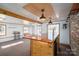 Open bar area with a custom wood bar, exposed beams, pendant lights, and light paint at 2073 Mauney Rd, Bessemer City, NC 28016