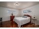 Cozy bedroom features hardwood floors, neutral paint, and ample natural light at 2073 Mauney Rd, Bessemer City, NC 28016
