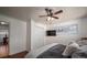 Bedroom featuring neutral walls, wood floor, ceiling fan, mounted flat-screen TV, and window with natural light at 2073 Mauney Rd, Bessemer City, NC 28016