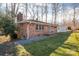 Side view of brick ranch with blue front door, nice lawn, and mature trees at 2073 Mauney Rd, Bessemer City, NC 28016