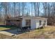 Charming brick home with a blue door, glass patio doors, and swing at 2073 Mauney Rd, Bessemer City, NC 28016