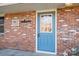 Charming home front entrance showcases a brick facade and a welcoming blue front door at 2073 Mauney Rd, Bessemer City, NC 28016