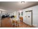 Kitchen featuring white cabinets and laminate floors that flow into a dining area and living room with a fireplace at 2073 Mauney Rd, Bessemer City, NC 28016