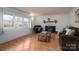 Bright living room features hardwood floors, a brick fireplace, and large windows at 2073 Mauney Rd, Bessemer City, NC 28016