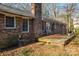 Brick home with wooden deck and leaf covered yard at 2111 Greenleaf Dr, Gastonia, NC 28054