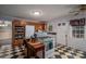 Kitchen features island, gas range, white appliances, and black and white floors at 2111 Greenleaf Dr, Gastonia, NC 28054