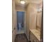 Bathroom with a view into the toilet room, sink with cabinet and light fixture at 2121 Carriage Woods Ln, Kannapolis, NC 28081