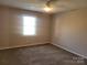 Bedroom with a window allowing ample natural light, complemented by carpet flooring at 2121 Carriage Woods Ln, Kannapolis, NC 28081