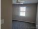 Well-lit bedroom with neutral walls and carpet flooring, illuminated by a window at 2121 Carriage Woods Ln, Kannapolis, NC 28081