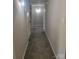 Apartment hallway featuring neutral paint, carpet, and lighting at 2121 Carriage Woods Ln, Kannapolis, NC 28081