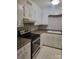 Kitchen featuring modern appliances, white cabinetry, and tile flooring for a clean, updated look at 2121 Carriage Woods Ln, Kannapolis, NC 28081