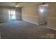 An open living room featuring neutral paint, carpet, and a sliding glass door leading to a balcony at 2121 Carriage Woods Ln, Kannapolis, NC 28081