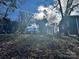 Sloped backyard with leaf-covered ground and trees at 323 Whispering Pines Dr, Charlotte, NC 28217