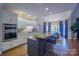 Modern kitchen with island, double oven, and granite countertops at 3788 Panthers Den Ct, Concord, NC 28027