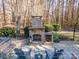 Elegant stone outdoor fireplace and seating area, great for relaxing evenings at 3788 Panthers Den Ct, Concord, NC 28027