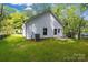 Exterior view of house with green backyard, back door, and A/C unit on the side at 408 N Boyd St, Gastonia, NC 28052