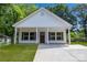 Inviting home showcasing a covered entrance, dark shutters, and a newly paved driveway at 408 N Boyd St, Gastonia, NC 28052