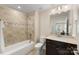 Clean bathroom with tub, shower, and dark vanity at 4219 Moxie Way, Charlotte, NC 28215