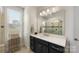 Elegant bathroom with dark vanity, shower, and plenty of counter space at 4219 Moxie Way, Charlotte, NC 28215