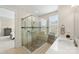 Bathroom with a walk-in shower, tiled walls, and modern vanity at 4219 Moxie Way, Charlotte, NC 28215