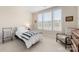 Small bedroom with a striped bedspread and a window seat at 4219 Moxie Way, Charlotte, NC 28215