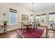 Charming dining area features hardwood floors, large windows, and red accent rug at 4219 Moxie Way, Charlotte, NC 28215