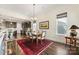 Bright dining room with hardwood floors and chandelier, adjacent to kitchen at 4219 Moxie Way, Charlotte, NC 28215