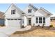 White two-story house with gray shutters and a two-car garage at 4219 Moxie Way, Charlotte, NC 28215