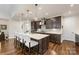 Modern kitchen with dark cabinetry, quartz countertops, and stainless steel appliances at 4219 Moxie Way, Charlotte, NC 28215