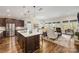 Open concept kitchen with island and views into the living room at 4219 Moxie Way, Charlotte, NC 28215