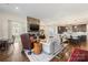 Open concept living room with kitchen views, stone fireplace and hardwood floors at 4219 Moxie Way, Charlotte, NC 28215