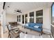 Screened porch with seating area, dining table and ceiling fan at 4219 Moxie Way, Charlotte, NC 28215