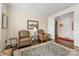Spacious sitting room featuring leather armchairs and hardwood floors at 4219 Moxie Way, Charlotte, NC 28215