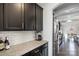 Kitchen with dark cabinets, granite countertops, and white subway tile backsplash at 5055 Stonehill Ln, Matthews, NC 28104