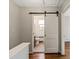 Updated bathroom with a barn door and tile flooring at 512 Wakefield Dr, Charlotte, NC 28209