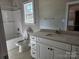 A bathroom with a shower/tub, white vanity, and a window for natural light at 609 Shiloh Unity Rd, Lancaster, SC 29720