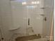 Modern bathroom with white tiled shower, glass enclosure, and built-in corner shelving for toiletries at 609 Shiloh Unity Rd, Lancaster, SC 29720